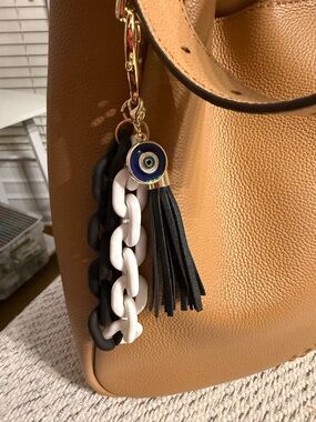 NEW. 🧿 🖤 Bag charm or keychain. Faux leather tassel, removable evil eye charm